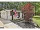 Charming home exterior with manicured landscaping and an American flag, exuding curb appeal at 306 N Meade Dr, Peachtree City, GA 30269