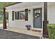 Inviting front entrance with dark shutters, stylish decor, and potted plants at 306 N Meade Dr, Peachtree City, GA 30269