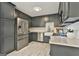 Well-equipped kitchen with stainless steel appliances, gray cabinets, and granite countertops at 306 N Meade Dr, Peachtree City, GA 30269