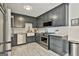 Modern kitchen with stainless steel appliances, gray cabinets, and stylish backsplash at 306 N Meade Dr, Peachtree City, GA 30269