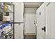 Functional laundry area equipped with a stacked washer and dryer, shelving, and exterior access at 306 N Meade Dr, Peachtree City, GA 30269