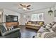 Cozy living room with hardwood floors, large windows, and comfortable furnishings at 306 N Meade Dr, Peachtree City, GA 30269