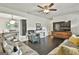 Open-concept living room featuring hardwood floors, an elegant dining area, and a TV at 306 N Meade Dr, Peachtree City, GA 30269