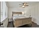 Inviting main bedroom featuring dark wood floors, neutral walls, and ceiling fan at 306 N Meade Dr, Peachtree City, GA 30269