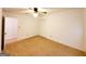 Bedroom featuring neutral carpet, ceiling fan, closet and access to the hallway at 1753 Brenda Dr, Jonesboro, GA 30236