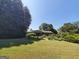 Landscaped front yard with mature trees and bushes at 1753 Brenda Dr, Jonesboro, GA 30236