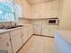 Bright kitchen featuring white cabinets, stainless steel sink, dishwasher, and ample counter space at 1753 Brenda Dr, Jonesboro, GA 30236