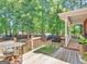 Outdoor deck featuring a grill, table, and wood pile, perfect for entertaining at 1302 Eddie Craig Ct, Mcdonough, GA 30252