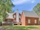 Expansive backyard showcasing the house, deck, and lush green space, ideal for outdoor activities at 1302 Eddie Craig Ct, Mcdonough, GA 30252