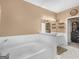 Bright bathroom with a large bathtub, white vanity, and stylish fixtures at 1302 Eddie Craig Ct, Mcdonough, GA 30252