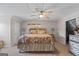 Cozy bedroom features a ceiling fan, neutral walls, and a comfortable floral-patterned bed at 1302 Eddie Craig Ct, Mcdonough, GA 30252