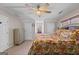 Comfortable bedroom with a floral patterned bedspread, carpet flooring, and double closet doors at 1302 Eddie Craig Ct, Mcdonough, GA 30252