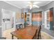 Bright dining area with ceiling fan, view to backyard, and adjacent laundry area at 1302 Eddie Craig Ct, Mcdonough, GA 30252