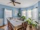 Charming dining room featuring blue walls, hardwood floors, and a ceiling fan at 1302 Eddie Craig Ct, Mcdonough, GA 30252
