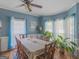 Charming dining room with hardwood floors, chair rail, ceiling fan, and plenty of natural light at 1302 Eddie Craig Ct, Mcdonough, GA 30252