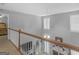 Open foyer overlooking the living room with a fireplace, with a wood banister at 1302 Eddie Craig Ct, Mcdonough, GA 30252
