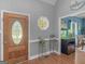A bright foyer with hardwood floors, decorative accents, and a clear view into the dining room at 1302 Eddie Craig Ct, Mcdonough, GA 30252