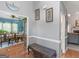 Foyer featuring hardwood floors, decorative bench, and views into the dining and living spaces at 1302 Eddie Craig Ct, Mcdonough, GA 30252