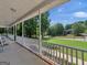 Inviting front porch with rocking chairs overlooking the lush green lawn and scenic neighborhood views at 1302 Eddie Craig Ct, Mcdonough, GA 30252