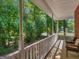Charming front porch offers serene views of the wooded landscape at 1302 Eddie Craig Ct, Mcdonough, GA 30252