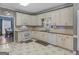 Bright kitchen with white cabinetry, white appliances, and view into the dining room at 1302 Eddie Craig Ct, Mcdonough, GA 30252
