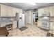 Spacious kitchen featuring ample cabinets, white appliances, and an adjacent dining area at 1302 Eddie Craig Ct, Mcdonough, GA 30252