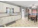 Functional kitchen with white cabinets, laminate countertops, and view into breakfast nook at 1302 Eddie Craig Ct, Mcdonough, GA 30252