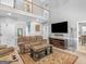 Inviting living room with high ceilings, staircase, comfortable seating, and large television at 1302 Eddie Craig Ct, Mcdonough, GA 30252