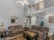 Spacious living room with high ceilings, comfortable seating, and neutral paint at 1302 Eddie Craig Ct, Mcdonough, GA 30252