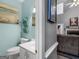 Charming powder room with blue walls, a stylish vanity, and decorative accents at 1302 Eddie Craig Ct, Mcdonough, GA 30252
