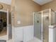 Modern bathroom featuring a glass-enclosed shower and clean, white tiled floors at 1302 Eddie Craig Ct, Mcdonough, GA 30252