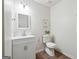 Clean bathroom with modern vanity, mirror, toilet, and wood-look vinyl floors at 4282 Worth Nw St, Acworth, GA 30101