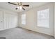 Bright bedroom featuring carpet, two windows, a ceiling fan, and a double door closet at 4282 Worth Nw St, Acworth, GA 30101