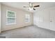 Bright bedroom featuring carpet, two windows, a ceiling fan, and a doorway to another room at 4282 Worth Nw St, Acworth, GA 30101
