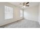Bright bedroom featuring neutral walls, carpet, a ceiling fan, and natural light from two windows at 4282 Worth Nw St, Acworth, GA 30101