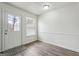 Well-lit dining area with neutral colors, a back door and light vinyl wood floors at 4282 Worth Nw St, Acworth, GA 30101