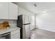 Bright eat-in kitchen area with white cabinets, stainless steel refrigerator and vinyl wood floors at 4282 Worth Nw St, Acworth, GA 30101