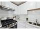 Modern kitchen with white cabinets, stainless steel appliances, and quartz countertops at 4282 Worth Nw St, Acworth, GA 30101
