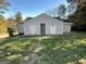 House exterior with signs of neglect, boarded up windows, and debris in the yard at 305 Fairburn Nw Rd, Atlanta, GA 30331
