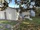 Exterior shot showing the light blue house with damage, boarded windows, and debris in the front yard at 305 Fairburn Nw Rd, Atlanta, GA 30331