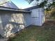 Side view of the light blue house with boarded-up windows at 305 Fairburn Nw Rd, Atlanta, GA 30331