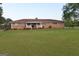 Classic brick home with a cozy front porch and spacious front yard, perfect for outdoor activities and relaxation at 2647 Mount Carmel Rd, Hampton, GA 30228
