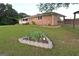 A well-manicured lawn surrounds the home, complemented by a lovely flower bed adding a touch of nature's beauty at 2647 Mount Carmel Rd, Hampton, GA 30228