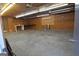 Unfinished garage interior with concrete floor and overhead lighting at 2647 Mount Carmel Rd, Hampton, GA 30228