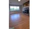 Spacious living room featuring hardwood floors, fireplace, and large window at 2647 Mount Carmel Rd, Hampton, GA 30228