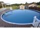 Above-ground pool with deck and ladder, perfect for summer fun at 2647 Mount Carmel Rd, Hampton, GA 30228
