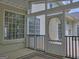 Inviting porch area with a wooden floor and screened windows, perfect for enjoying the outdoors at 187 Eagles Club Dr, Stockbridge, GA 30281