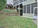 Professionally landscaped back yard featuring grass, flowers, patio and screened porch at 187 Eagles Club Dr, Stockbridge, GA 30281
