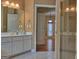 Bright bathroom featuring double vanity with sleek countertops and a glass-enclosed shower at 187 Eagles Club Dr, Stockbridge, GA 30281