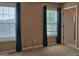 Carpeted bedroom with natural light, complemented by blue curtains, and easy access to ensuite bathroom at 187 Eagles Club Dr, Stockbridge, GA 30281